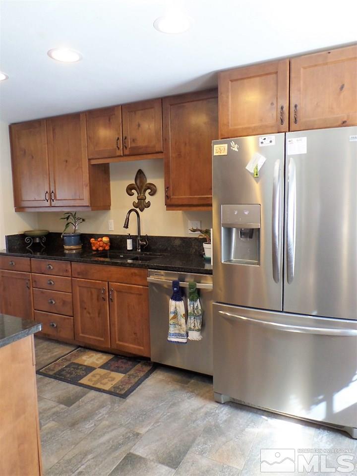 2590 Trentham Way Reno, NV 89509 - Photo 17 of 25 a kitchen with stainless steel appliances granite countertop a refrigerator a sink and a stove