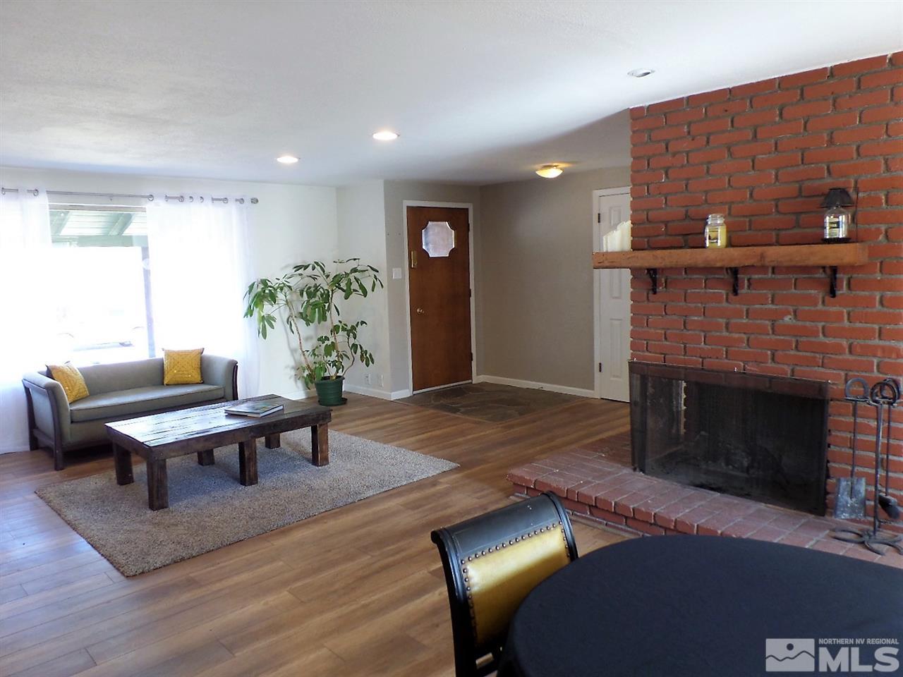 2590 Trentham Way Reno, NV 89509 - Photo 6 of 25 a living room with furniture a window and a fireplace