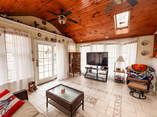 a living room with furniture and flat screen tv
