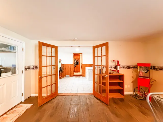 a view of a bedroom with furniture and wooden floor