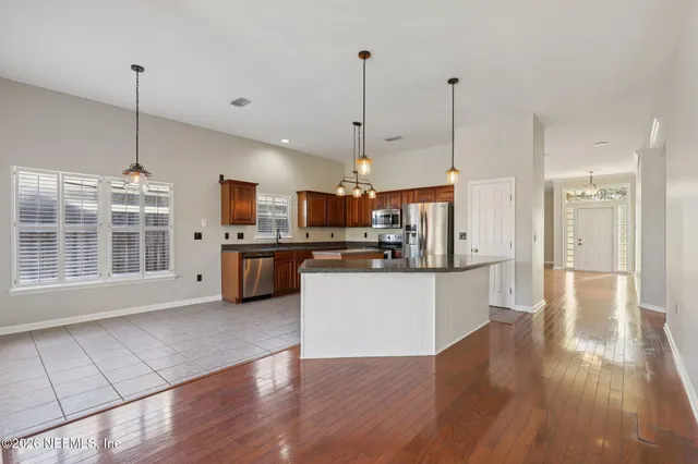 a kitchen with stainless steel appliances granite countertop sink stove and refrigerator