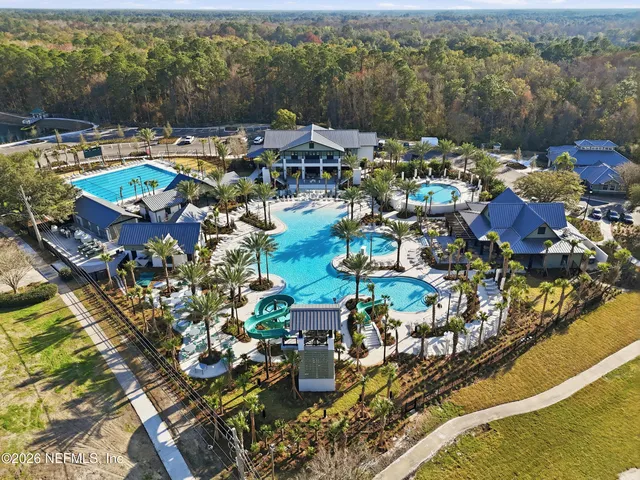 an aerial view of a houses with a swimming pool