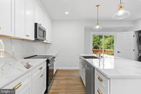 a kitchen that has a sink and a stove