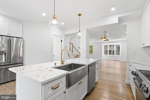 a kitchen with sink and refrigerator