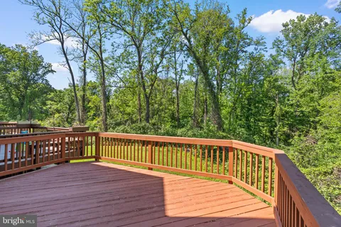 a view of balcony with wooden floor and fence