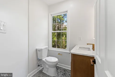 a bathroom with a toilet sink and a mirror