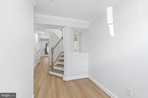 a view of entryway and hall with wooden floor