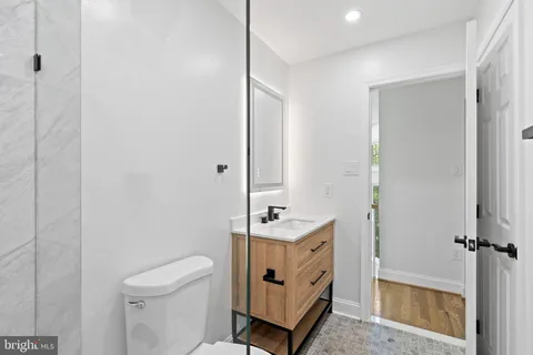 a bathroom with a sink a toilet and a mirror