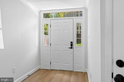 a view of an entryway with wooden floor