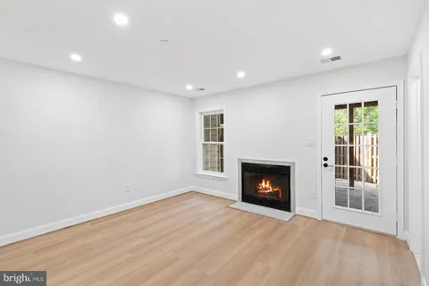 a view of an empty room with a fireplace