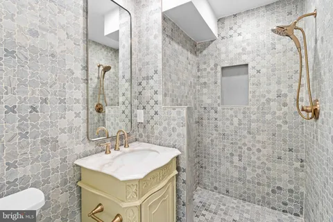 a bathroom with a sink toilet and shower