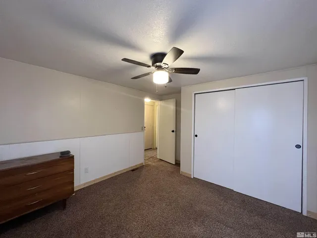 a furnished livingroom with a ceiling fan