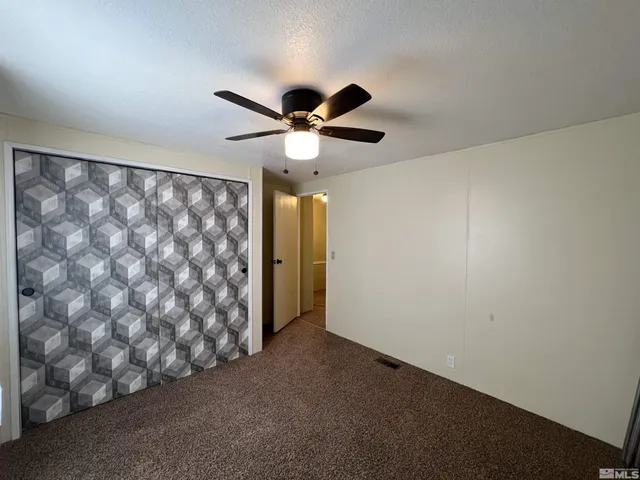 a very nice looking room with a ceiling fan and a window