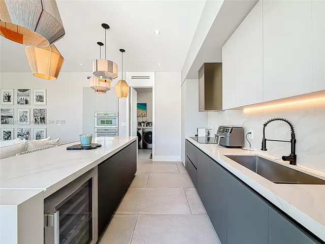 a large kitchen with stainless steel appliances lots of counter space and a sink