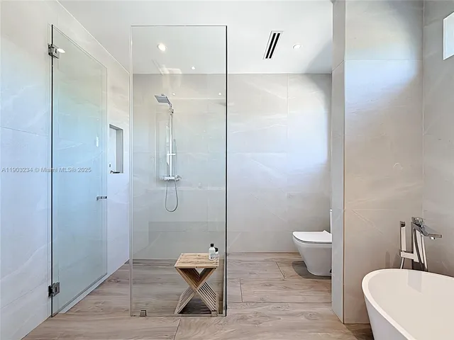 a bathroom with a toilet a sink and shower