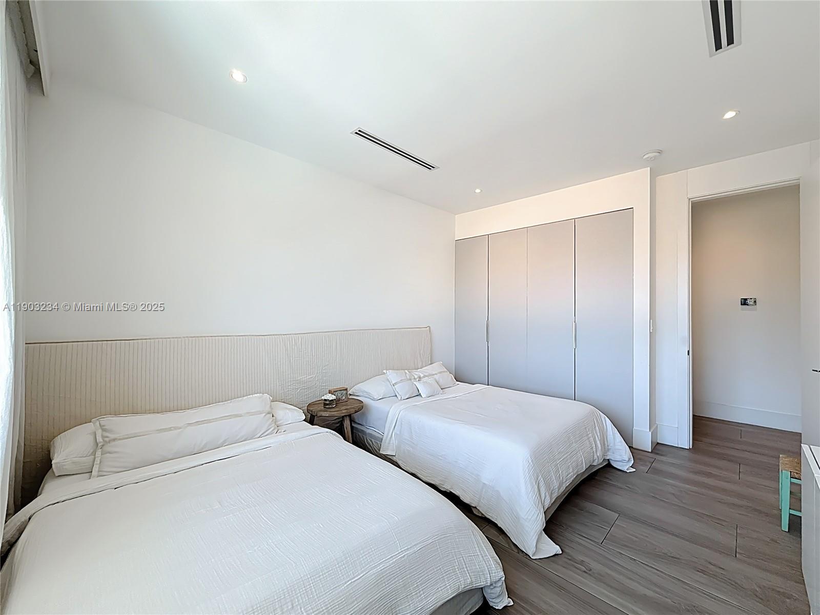 Key Biscayne Key Biscayne, FL 33149 - Photo 30 of 46 a bedroom with two bed and a night stand