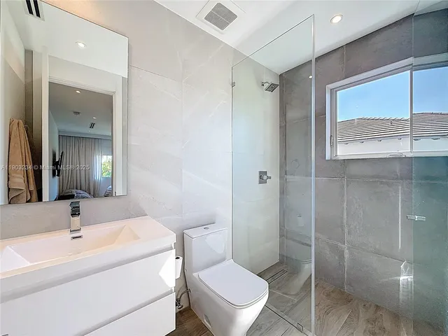 a bathroom with a toilet sink and shower