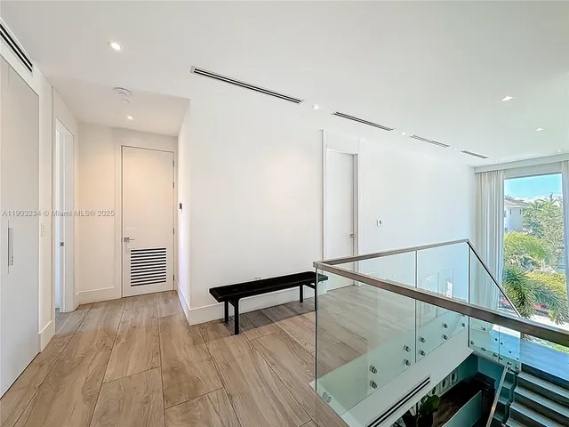 a view of an entryway with wooden floor
