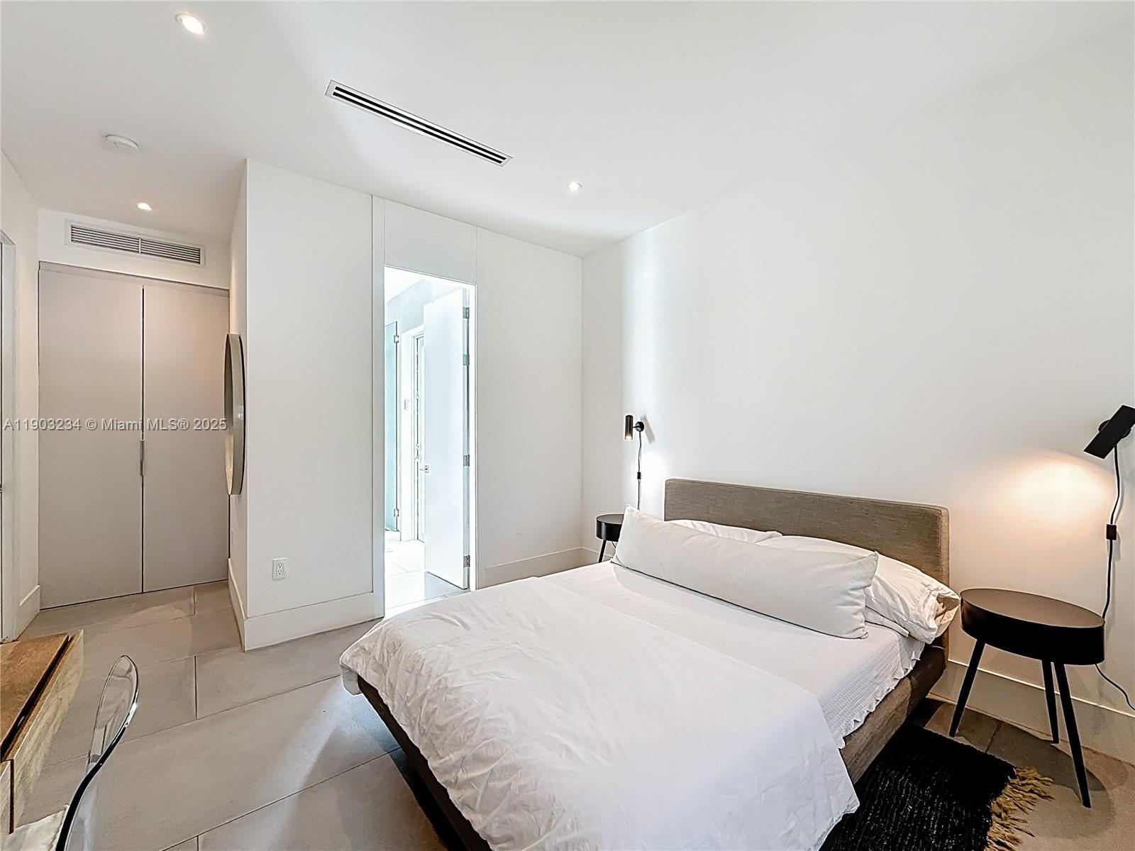 Key Biscayne Key Biscayne, FL 33149 - Photo 36 of 46 a bedroom with a bed and a lamp