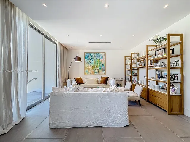 a living room with furniture and a book shelf