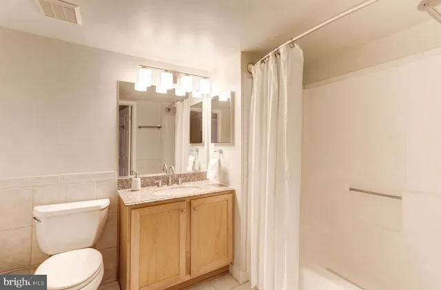 a bedroom with a large bed and a large window