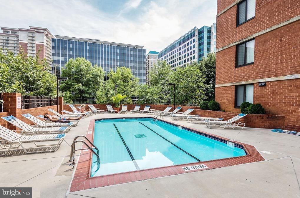 1001 North Randolph Street, Unit 406 Arlington, VA 22201 - Photo 14 of 23 a view of a swimming pool with a lounge chairs