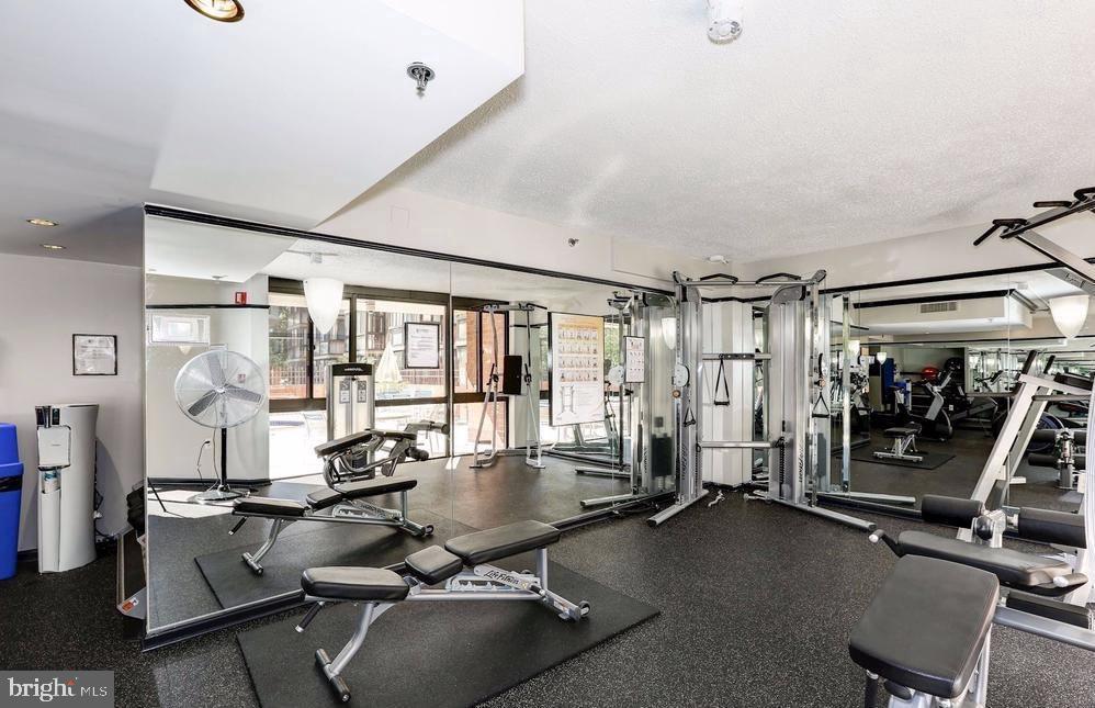 1001 North Randolph Street, Unit 406 Arlington, VA 22201 - Photo 16 of 23 a room with gym equipment and a large window