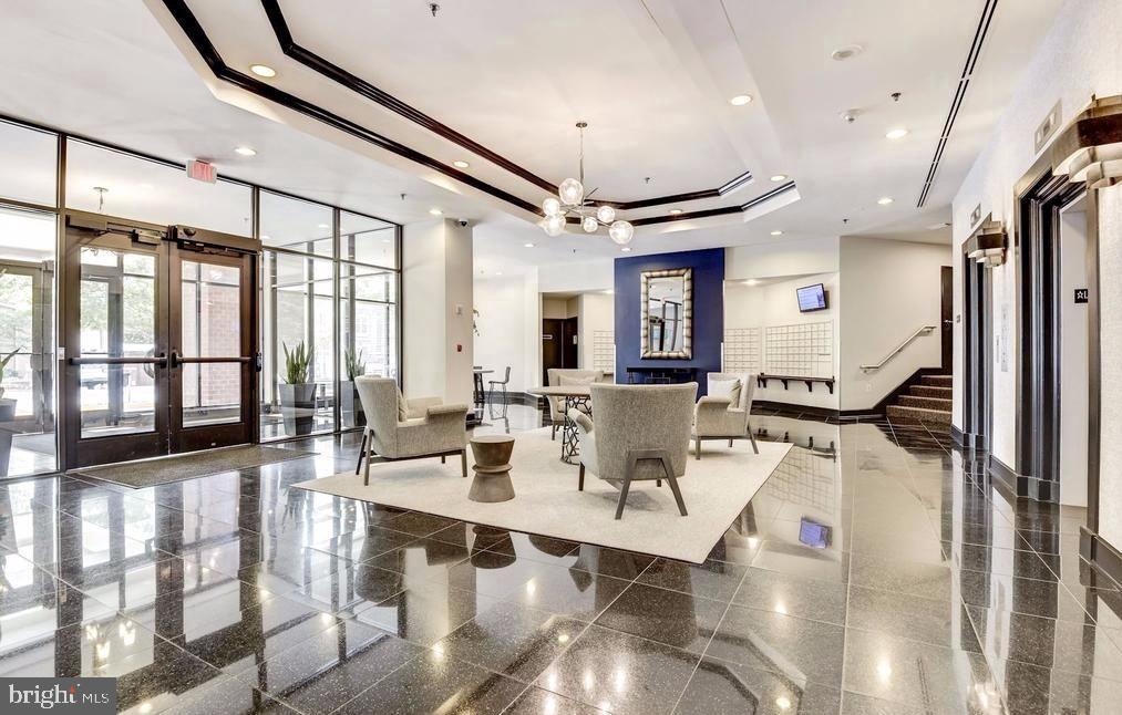 1001 North Randolph Street, Unit 406 Arlington, VA 22201 - Photo 17 of 23 a view of a patio with dining table and chairs