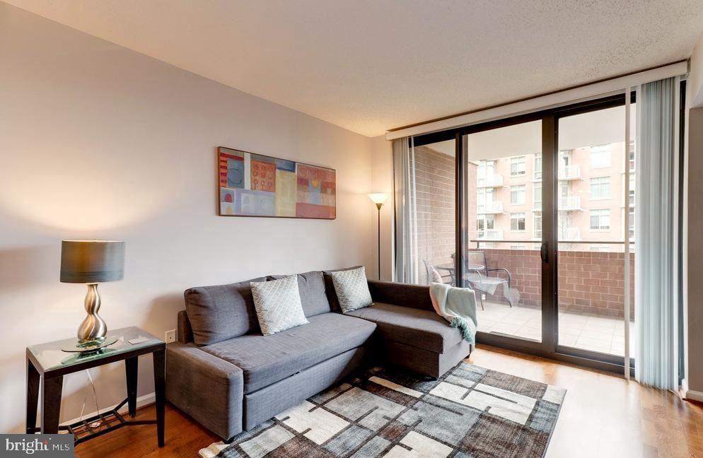 1001 North Randolph Street, Unit 406 Arlington, VA 22201 - Photo 2 of 23 a spacious bedroom with a bed and glass window