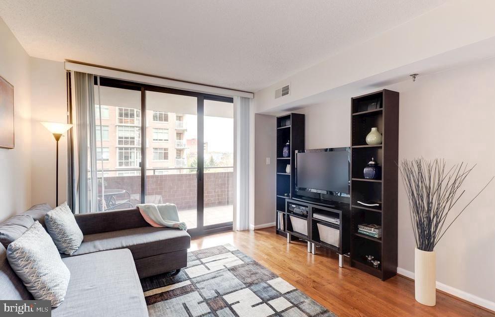 1001 North Randolph Street, Unit 406 Arlington, VA 22201 - Photo 3 of 23 a living room with furniture and a flat screen tv