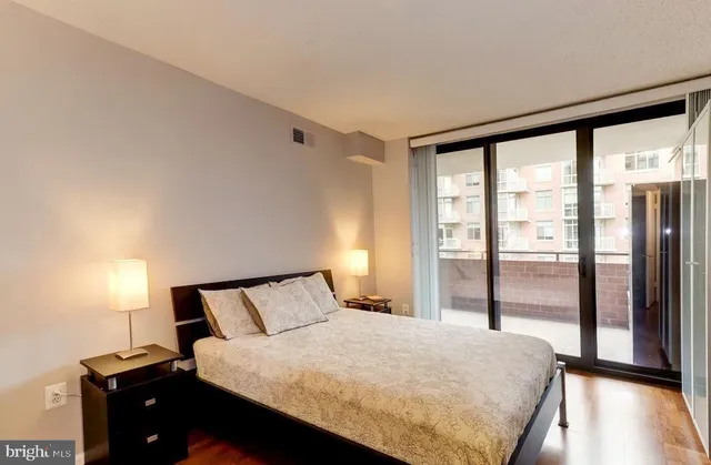 a bedroom with a bed and a large window