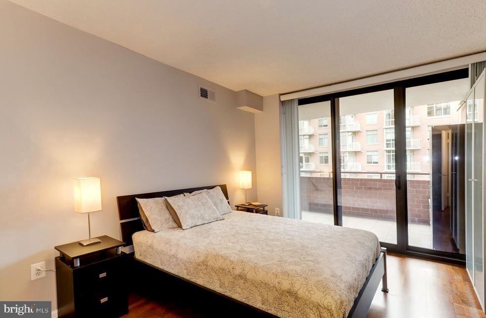 1001 North Randolph Street, Unit 406 Arlington, VA 22201 - Photo 9 of 23 a bedroom with a large bed and a large window
