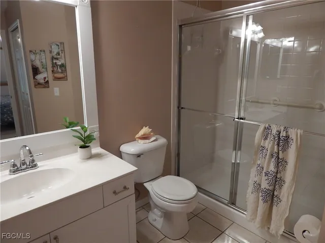 a white toilet sitting next to a bathroom sink