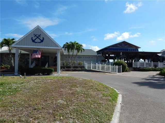 a view of a house with large windows and a yard
