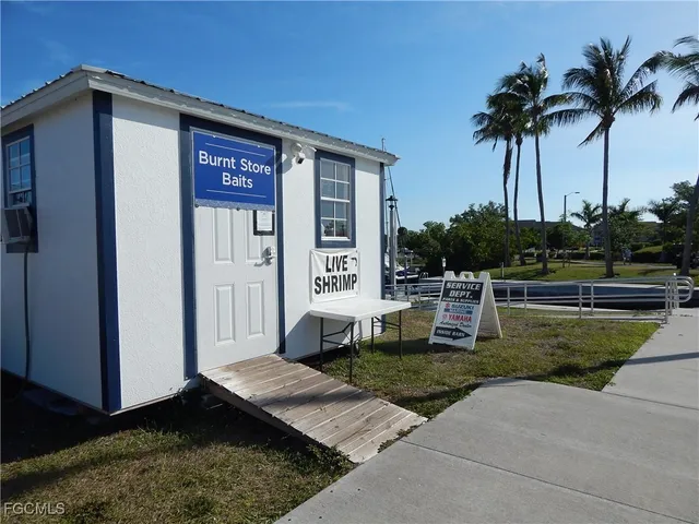 a view of a house with many windows and a yard