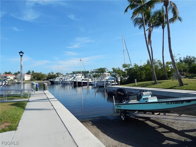a view of a lake with chairs