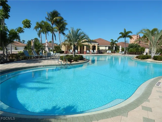 a view of a swimming pool and lounge chair