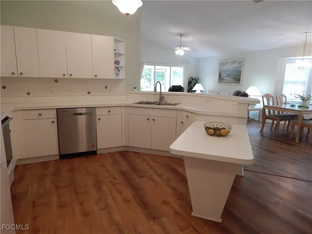 a kitchen with a sink appliances and cabinets