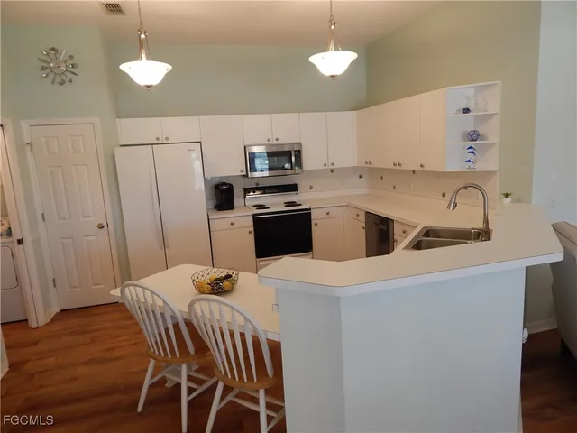 a kitchen with a sink a stove and refrigerator