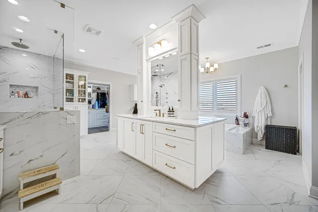 a bathroom with a granite countertop sink a toilet and a mirror