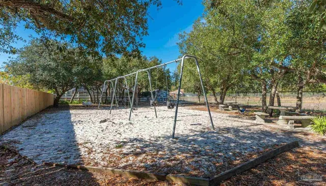 a view of a park with swings and a trees
