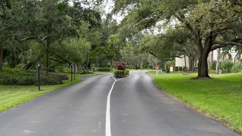 a kitchen with a sink a counter top space and living room view