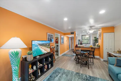 a living room with furniture and a dining table