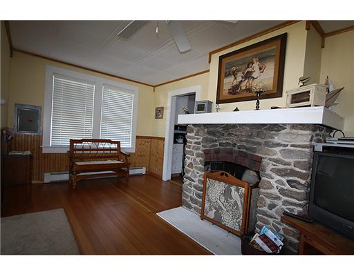 11 Allens Cove Road Charlestown, RI 02813 - Photo 5 of 11 Living Room. Warm and cozy, hardwood floors and fireplace.