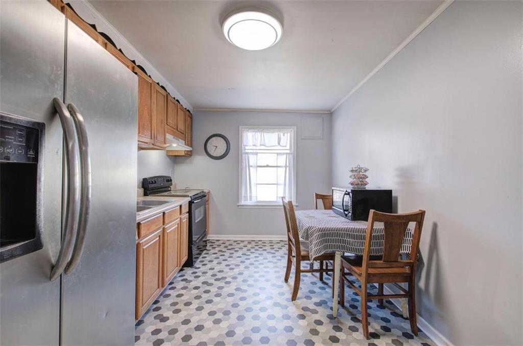 92 South Avery Road Southwest Rome, GA 30165 - Photo 16 of 39 a kitchen with stainless steel appliances granite countertop a sink a stove a refrigerator with a dining table and chair