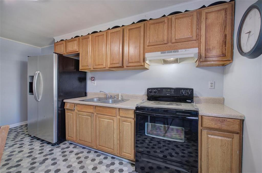 92 South Avery Road Southwest Rome, GA 30165 - Photo 18 of 39 a kitchen with stainless steel appliances granite countertop a stove a refrigerator and cabinets