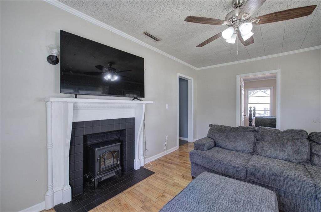 92 South Avery Road Southwest Rome, GA 30165 - Photo 9 of 39 a living room with furniture a flat screen tv and a fireplace