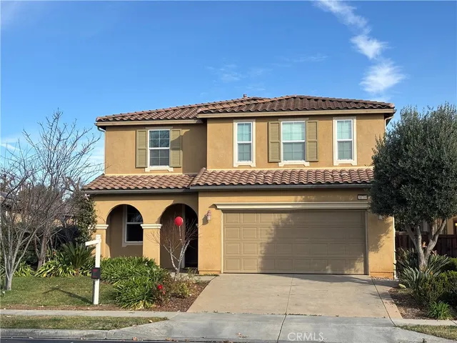 a front view of a house with yard