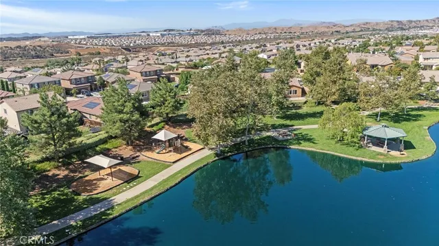 an aerial view of residential houses with outdoor space and river