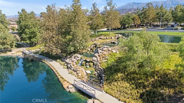 an aerial view of a residential houses with outdoor space and lake view